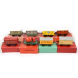 Eight early Hornby O gauge model railway vans and rolling stock.