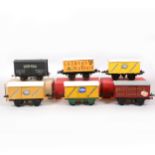 Six Hornby and kit-built O gauge model railway vans with advertising