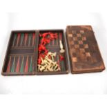 A part set of ivory and stained red chess pieces and two games boxes.