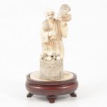 Japanese carved ivory okimono of a street vendor