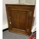 George II oak and fruitwood banded hanging corner cupboard,