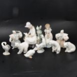 Three Lladro polar bears, other Nao and similar Spanish figurines.