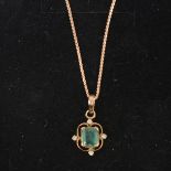 An emerald and diamond pendant and chain.