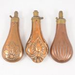 Three brass and copper shot flasks,