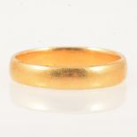 A 22 carat yellow gold wedding band.