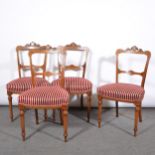 Set of four Edwardian walnut and inlaid balloon-back dining chairs, and another chair