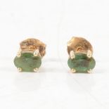 A pair of emerald stud earrings for pierced ears.