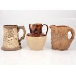 Continental pottery hunting tankard and two stoneware jugs,