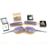 Four purple enamel and silver backed brushes, plus silver and white metal jewellery.