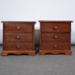 Two miniature chests of drawers.