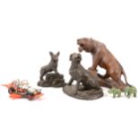Two bronzed resin figures of dogs, a carved tiger, etc
