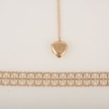 A 9 carat yellow gold bracelet and a a 9 carat back and front heart shaped locket on chain.