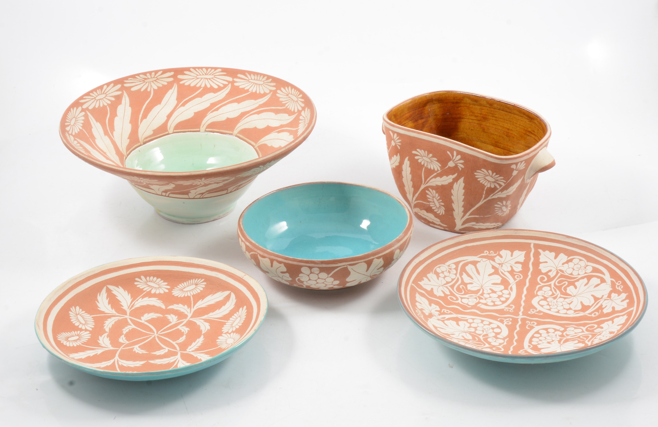 Five pieces of terracotta sgraffito ware by William and Gaye Fishley Holland.