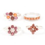 Gemporia - Four garnet set rings.