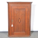 George III oak hanging corner cupboard,