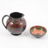 Moorcroft Pottery, flambe Anemone jug, and a flambe Hibiscus dish