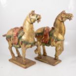 Pair of Chinese carved and gold painted wood models of Tang horses,