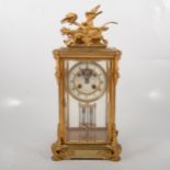 French gilt metal four-glass mantal clock