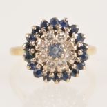 A sapphire and diamond circular cluster ring.