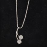A diamond cluster pendant and chain.