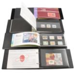 Fourteen Guernsey Post Office binders containing mint stamp sets.