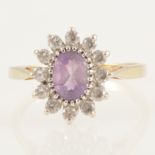 An amethyst and colourless stone cluster ring.