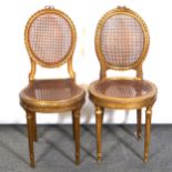 Pair of French gilt wood and cane panelled side chairs,