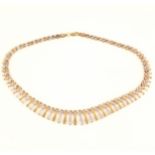 A 9 carat yellow and white gold fringe necklace.