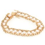 A 9 carat gold bracelet set with a row of cultured pearls.
