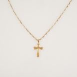 A yellow metal crucifix pendant on a yellow metal chain.