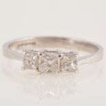A princess cut diamond three stone ring.