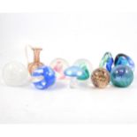 Nine Caithness and other glass paperweights, and a Murano glass vase.