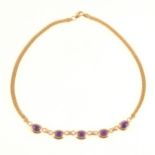 A 9 carat yellow gold amethyst necklace.