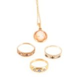 Three gemset rings and a cameo pendant and chain.