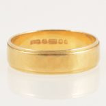 An 18 carat yellow gold wedding band.