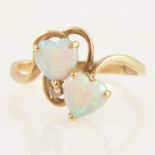 A crossover ring set with two heart shaped opals.
