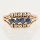 A sapphire and diamond three row ring.