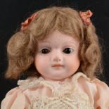 A Victorian bisque head doll, unmarked, fixed eyes, closed mouth