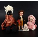 Four early 20th century small dolls, including tiny all bisque baby doll