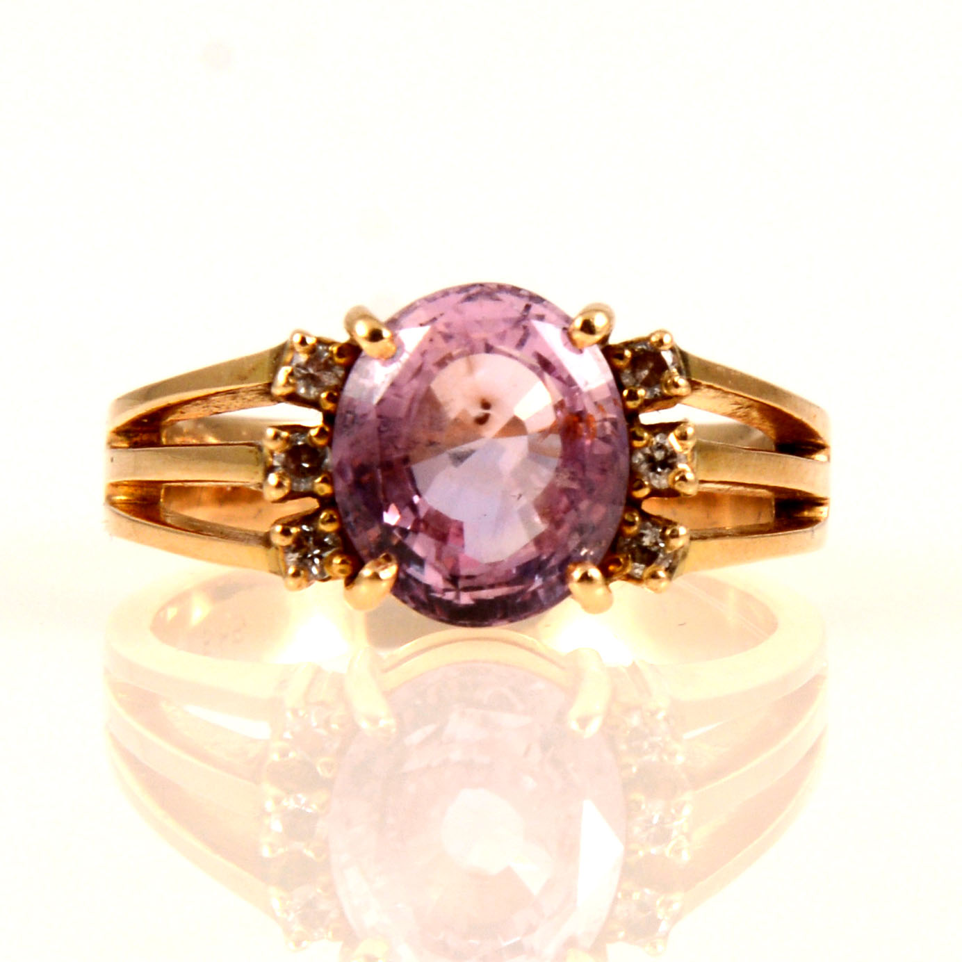 A synthetic pink sapphire and diamond ring.