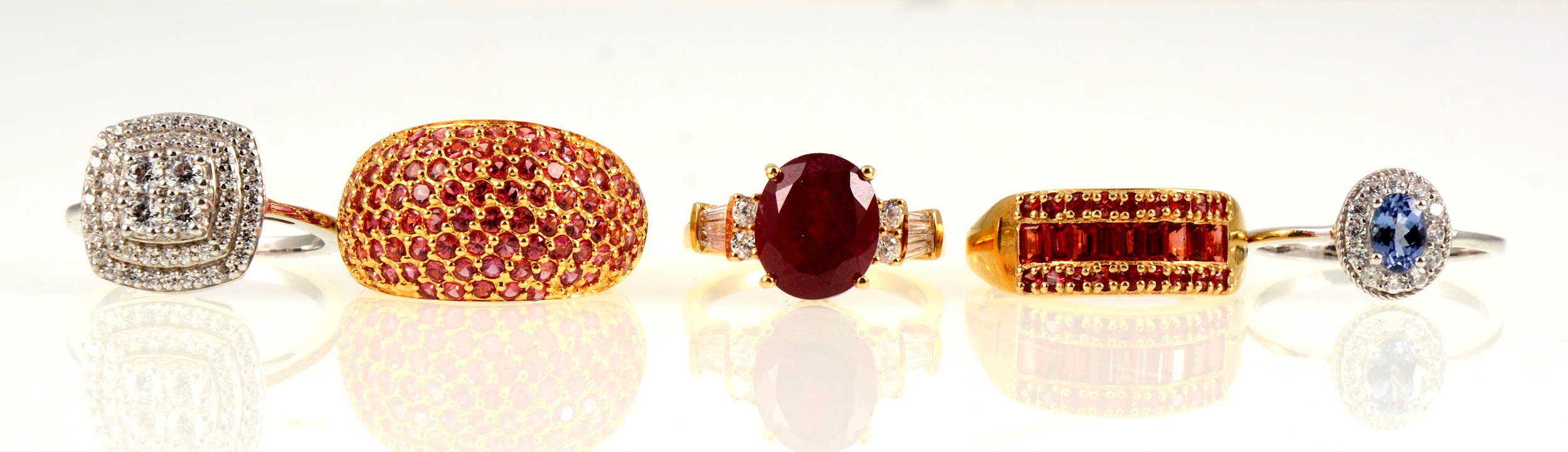 Five silver and silver-gilt gemset dress rings.