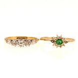 A diamond three stone ring and an emerald cluster ring.