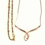 A 9 carat yellow and white gold bead necklace and diamond set necklace.