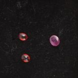 Gem Collector - Three loose, faceted rubies.