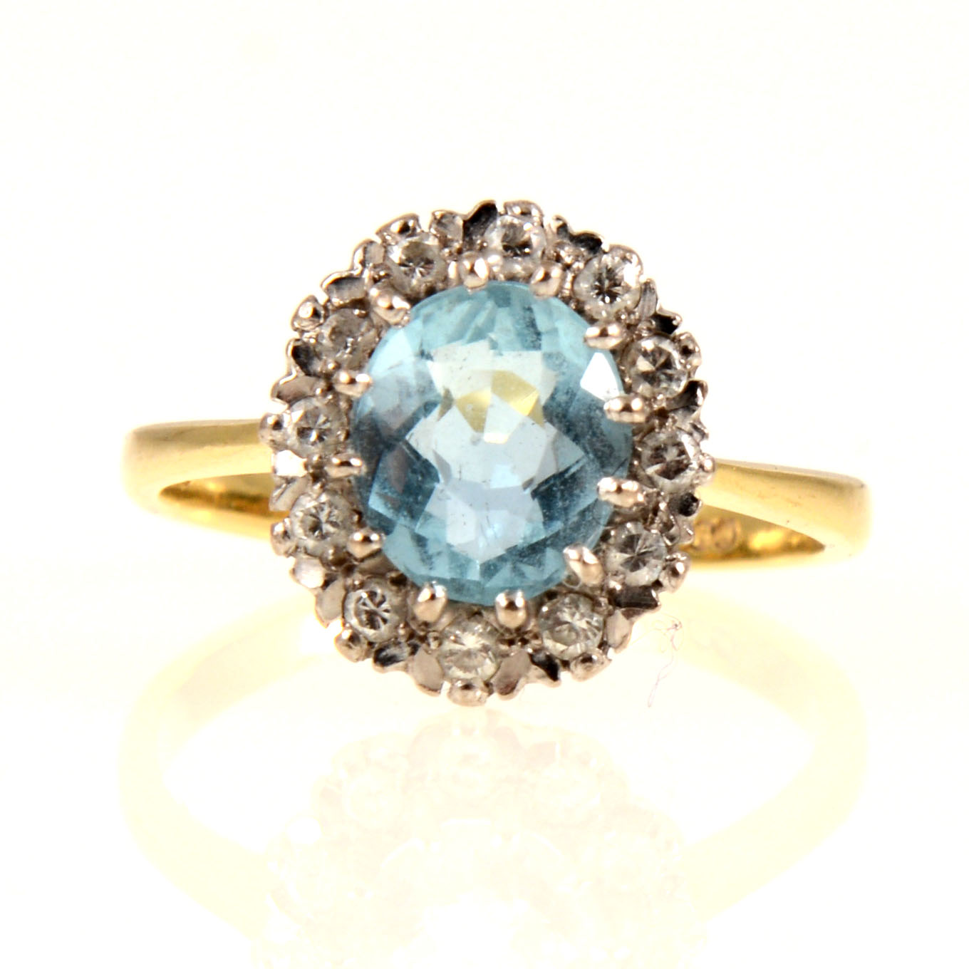 An aquamarine and diamond oval cluster ring.