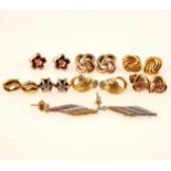 Eight pairs of 9 carat gold and silver earrings for pierced ears.