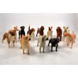 Twelve Beswick dogs.