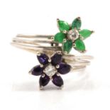 An emerald and amethyst dress ring.