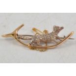 A diamond set running fox brooch.