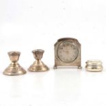 Small silver-cased table clock, pedestal salts, dressing table set, and other small silver items.